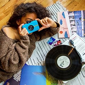 blue Polaroid camera with disco